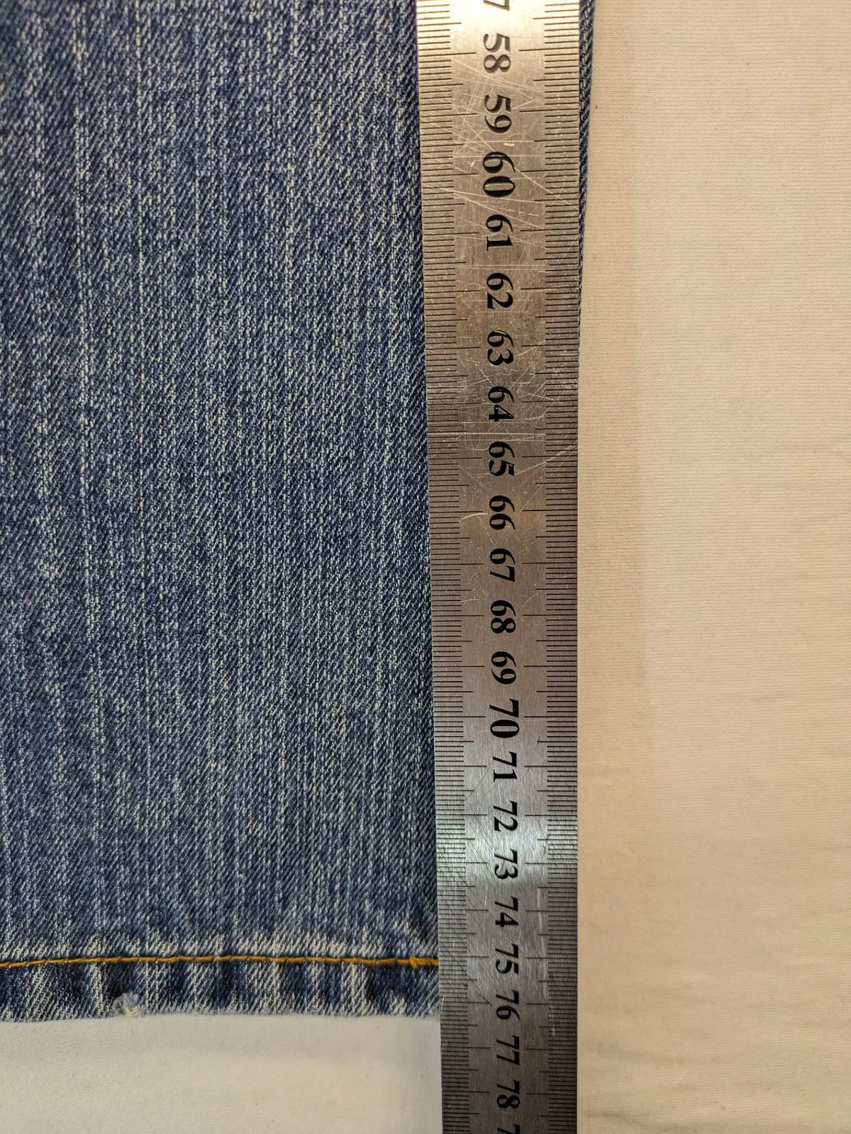 Zuni blue straight jeans 5-pocket design with zipper and decorative rivets.