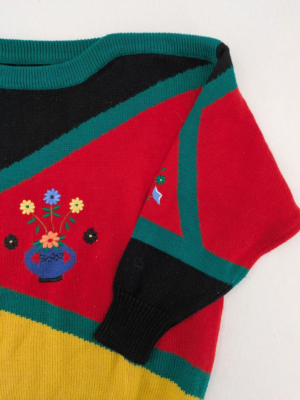 Pullover multi knit jumper featuring colorful block pattern and embroidered rooster and flowers.