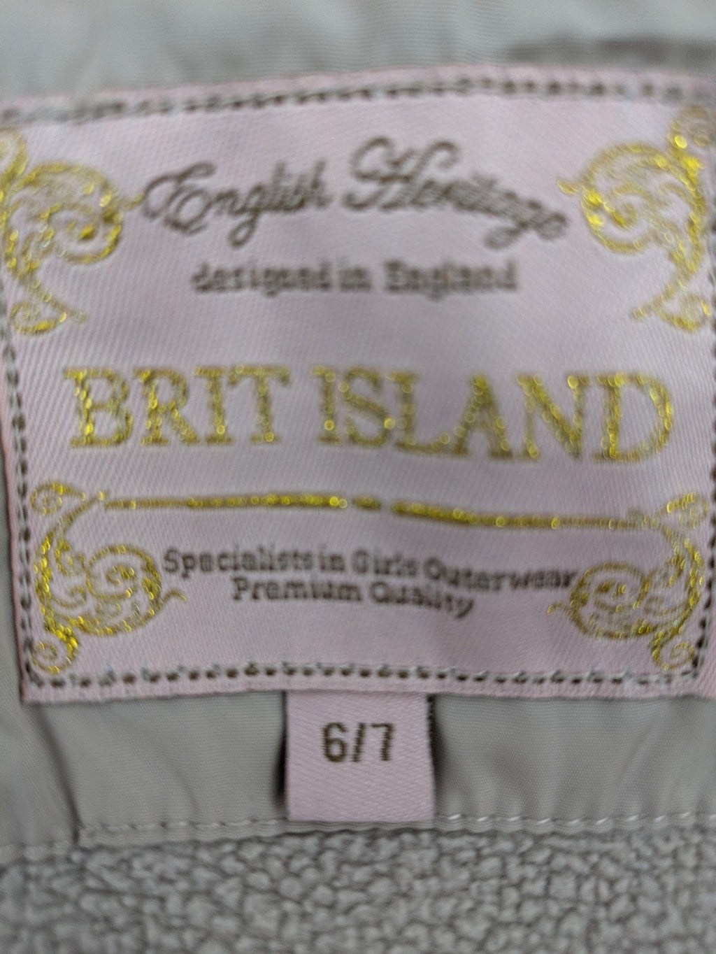 Brit Island beige puffer coat with fleece lining and faux fur hood detail.