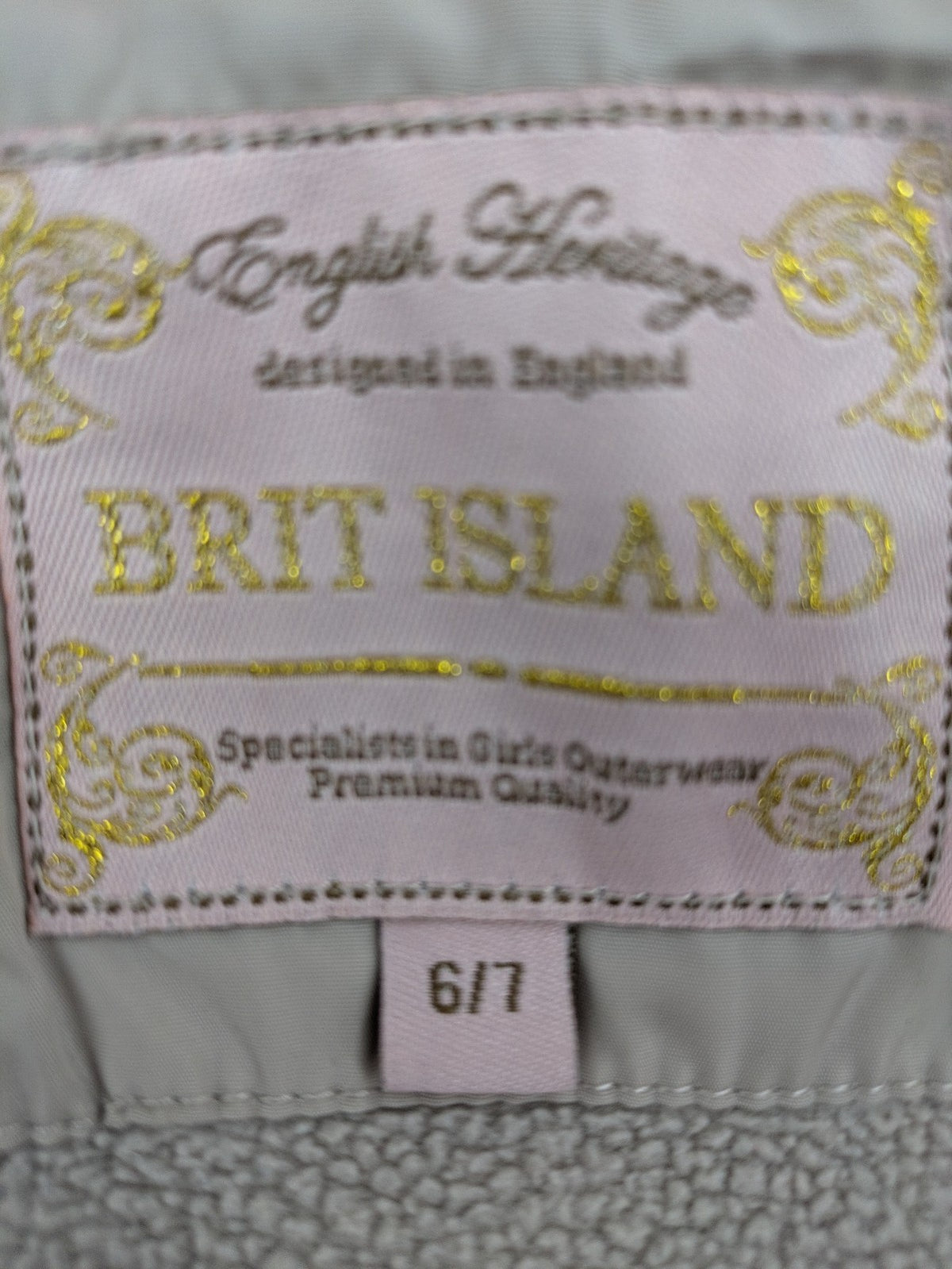 Brit Island beige puffer coat with fleece lining and faux fur hood detail.