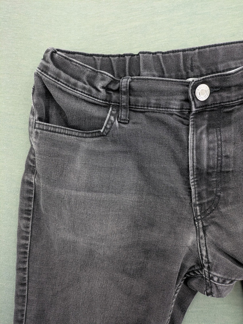 H&M grey slim fit jeans with adjustable waistband and faded wash detail.