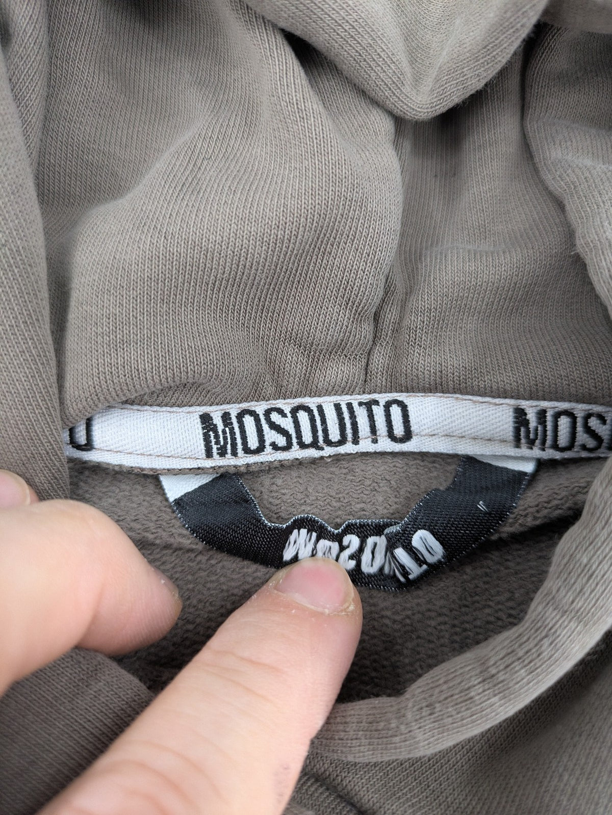 Mosquito grey hoodie with distressed cuffs and subtle logo on the chest.