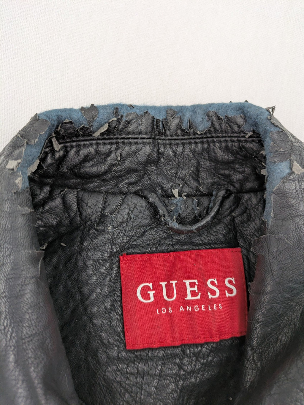 Guess black faux leather biker jacket with asymmetric zipper and multiple zip pockets.