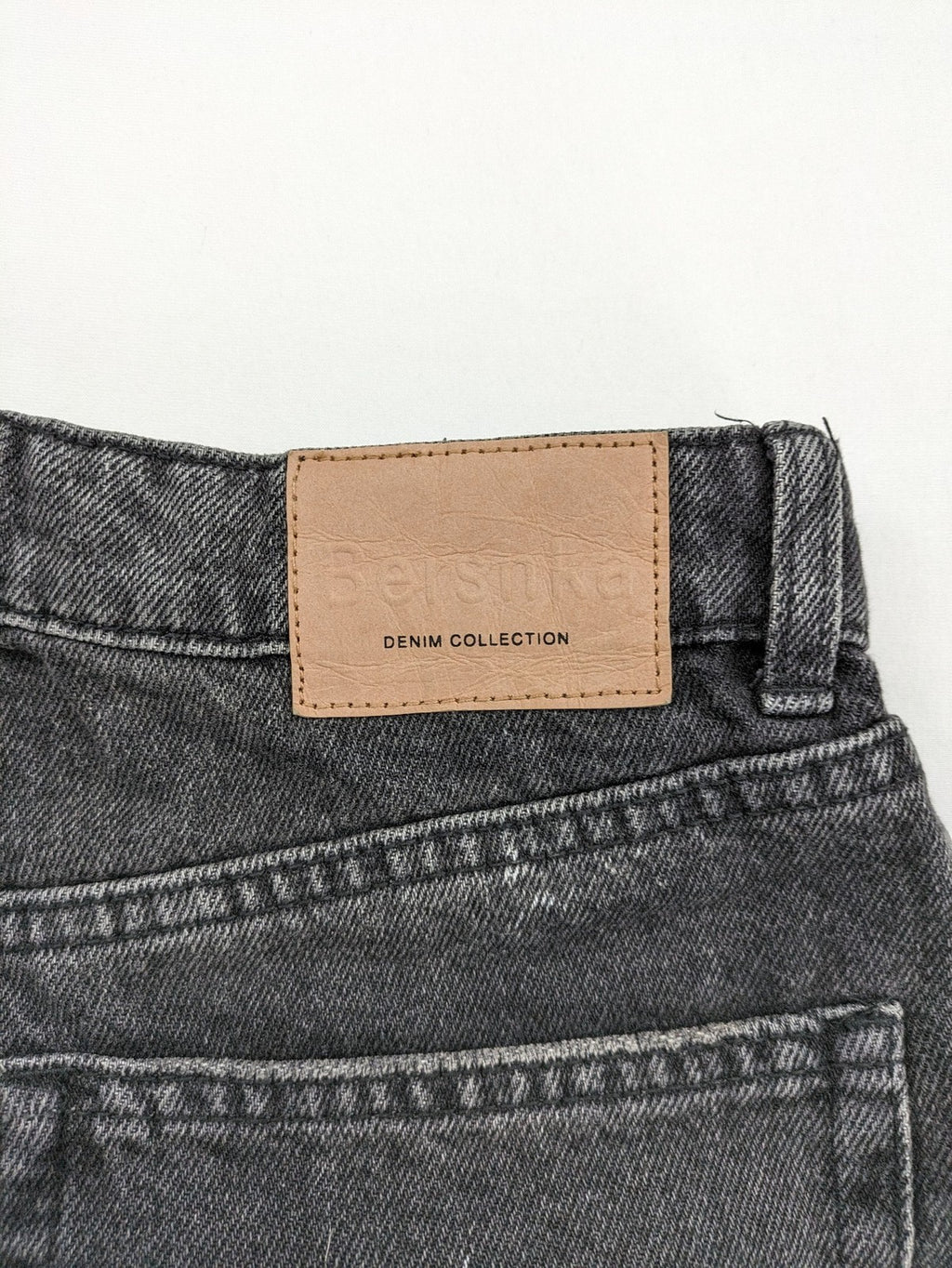 Bershka black mom jeans high-waist straight leg washed denim with classic five-pocket design.