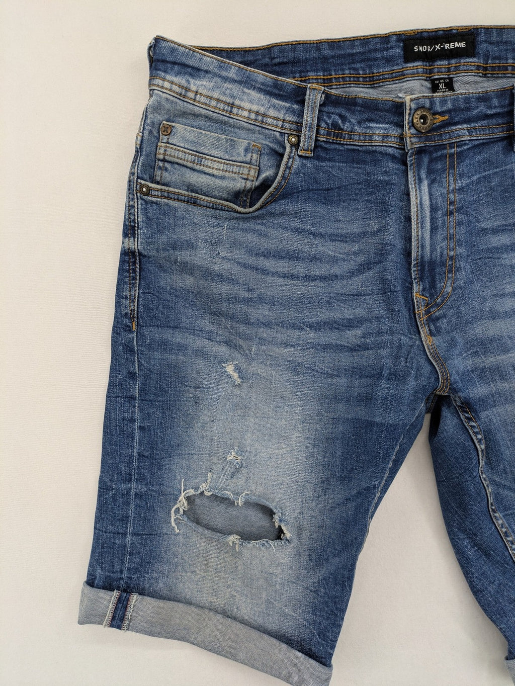 Smog blue denim shorts slim fit distressed details with rolled hem.