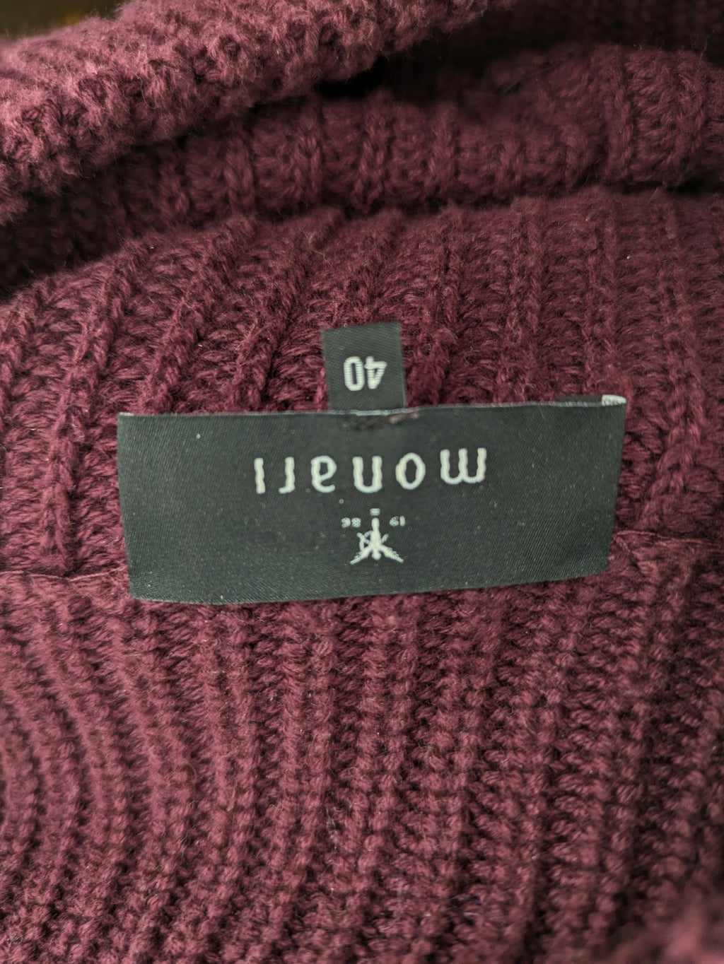 Monari burgundy knit jumper with standing collar, ribbed texture, and raglan sleeves.