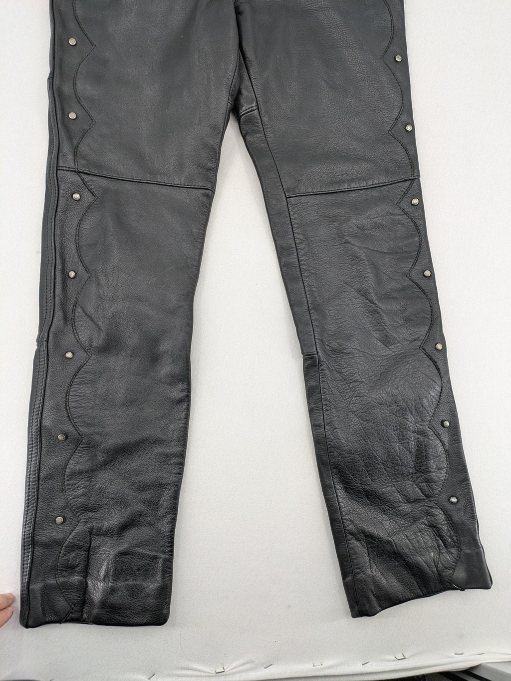 Hein Gericke black leather chaps with studs and wavy decorative seams.