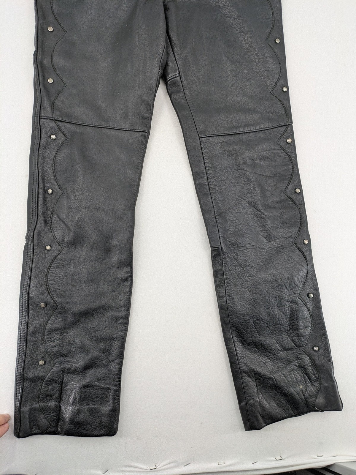 Hein Gericke black leather chaps with studs and wavy decorative seams.