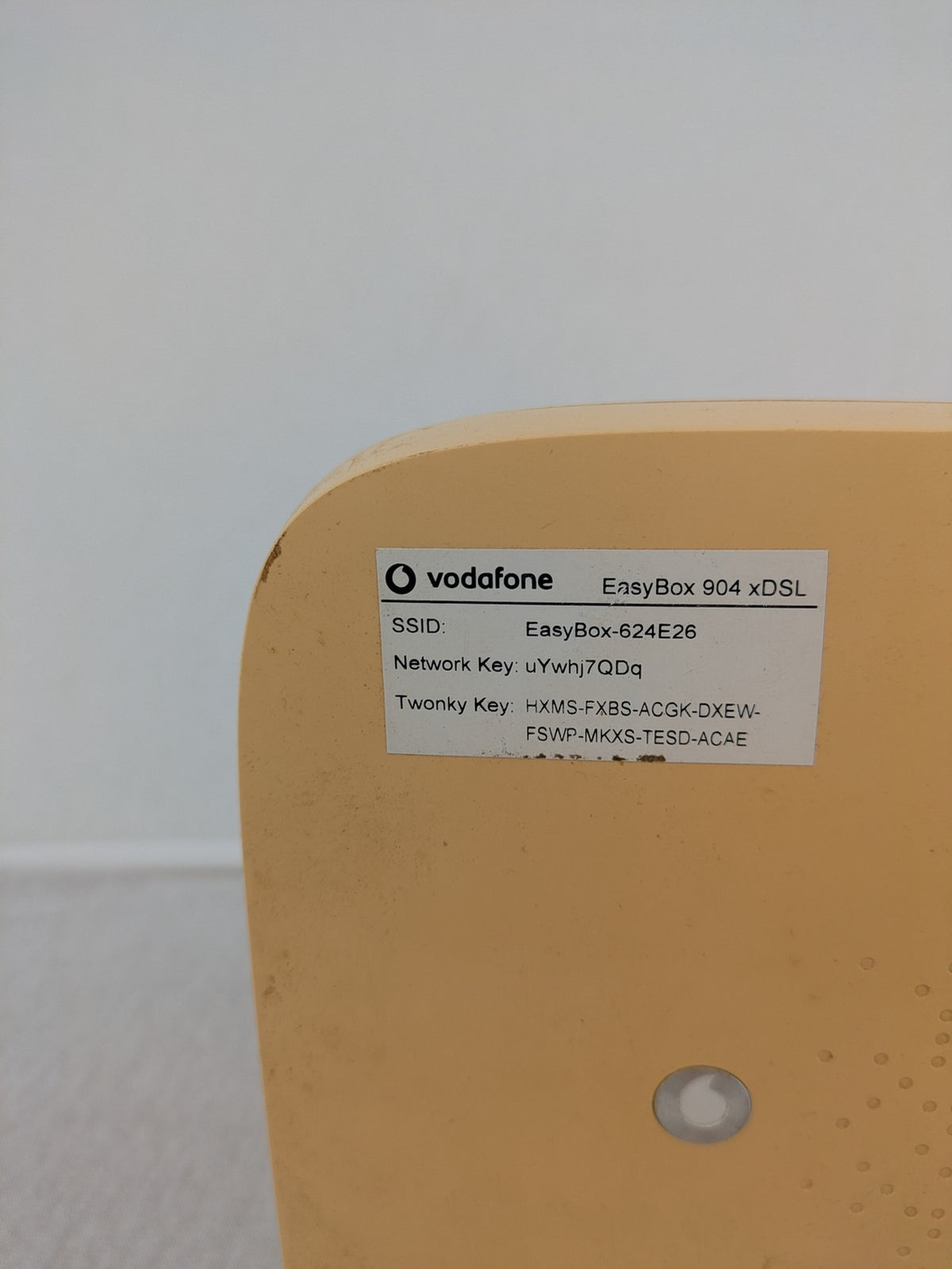 Vodafone beige wireless router with multiple LAN ports and DSL connectivity.