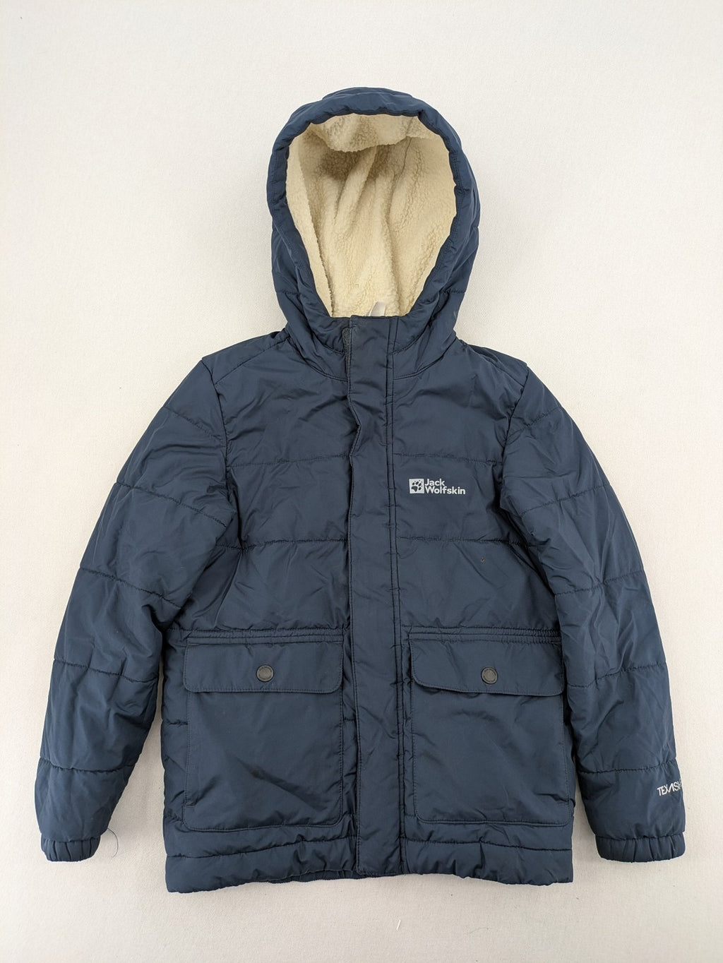 Jack Wolfskin cream and navy puffer coat with quilted design and Sherpa fleece lining.