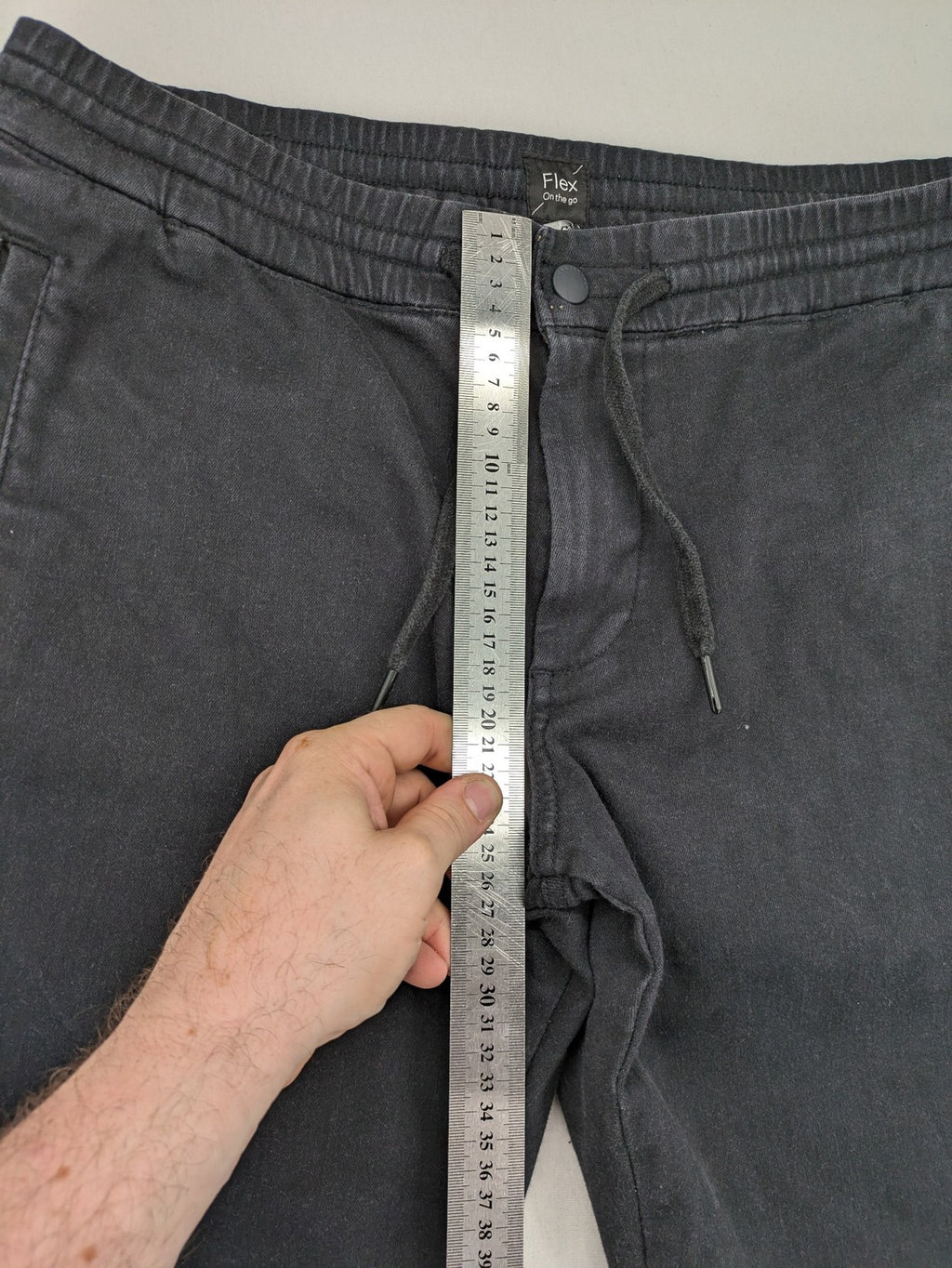 C&A grey jogger pants with elastic cuffs, drawstring waist, and multiple pockets.