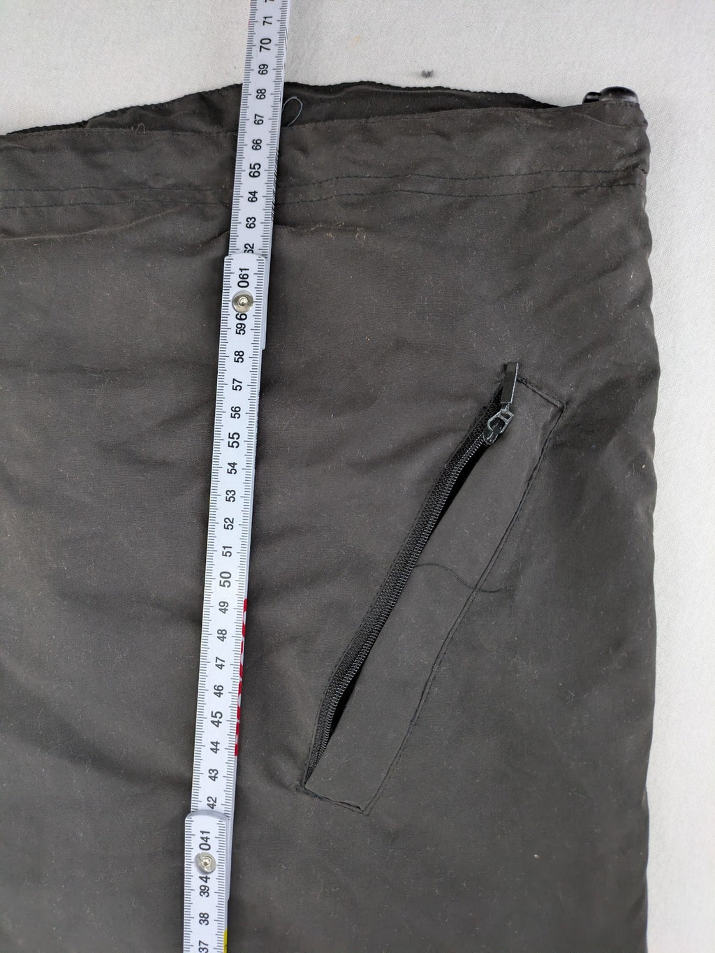 Tombo green windbreaker jacket with white piping, V-neck, and zippered pockets.