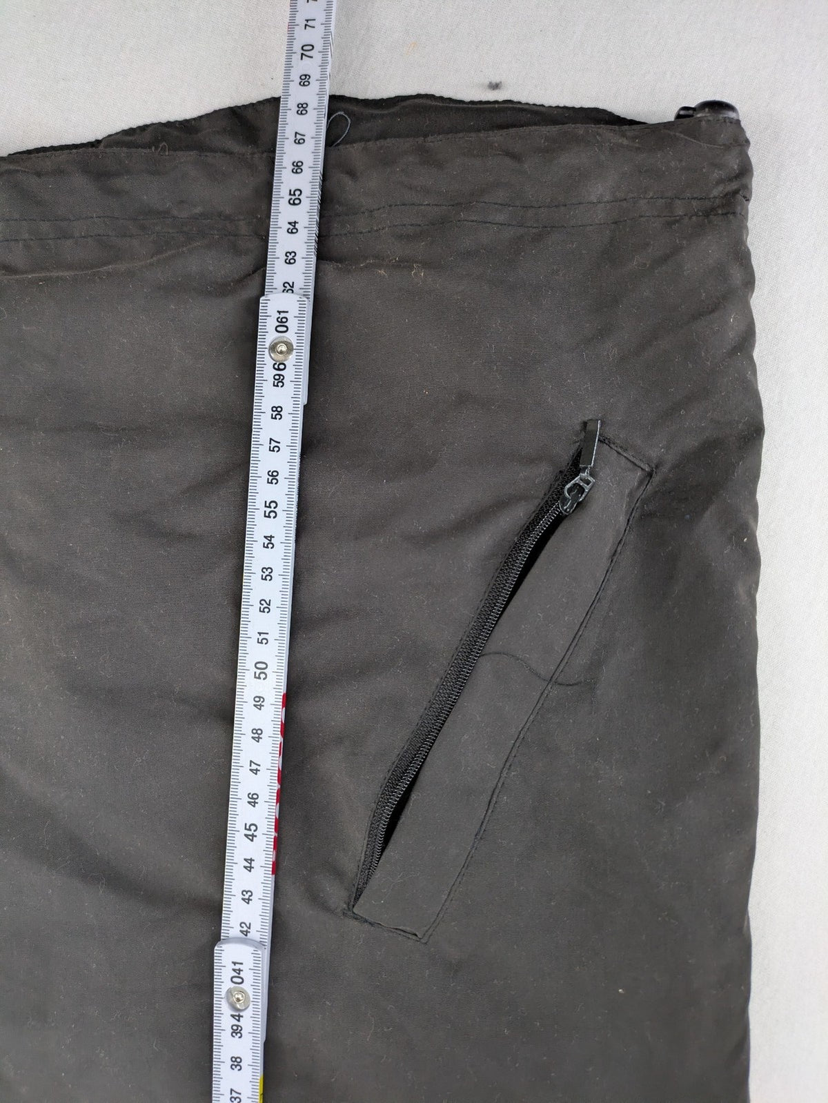 Tombo green windbreaker jacket with white piping, V-neck, and zippered pockets.