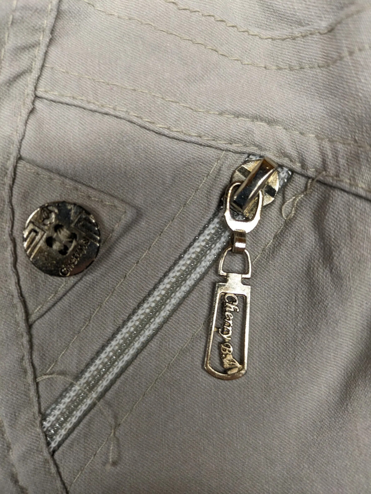 Cherry Berry khaki capri pants with elastic waistband and decorative buttons, featuring logo and zip pockets.