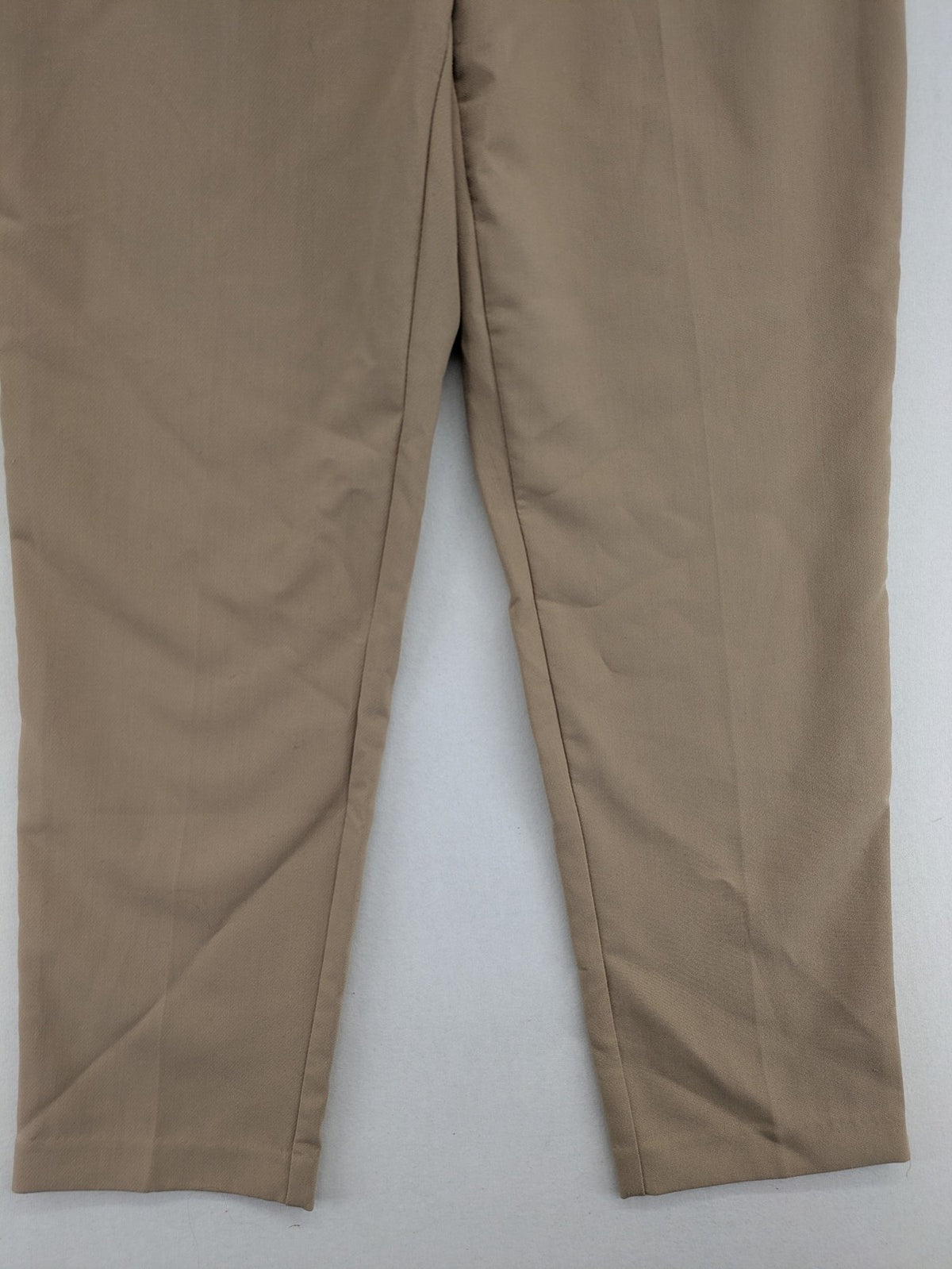 Tapered beige pants high-waist tapered fit with classic front creases and side pockets.