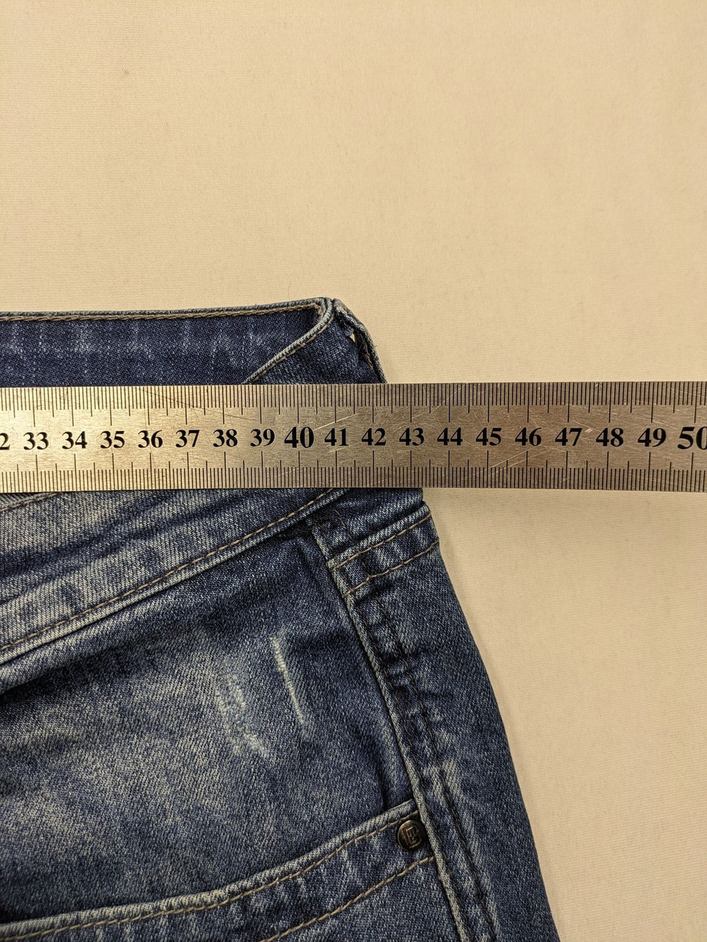 Brandit blue straight jeans with distressed details, button fly, and classic 5-pocket style.