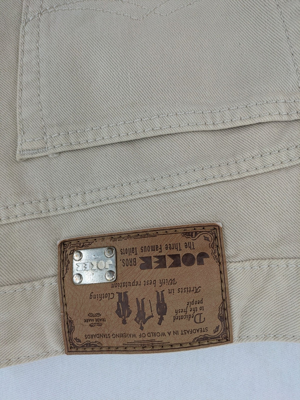 Joker beige straight jeans 5-pocket design with zipper and button closure.