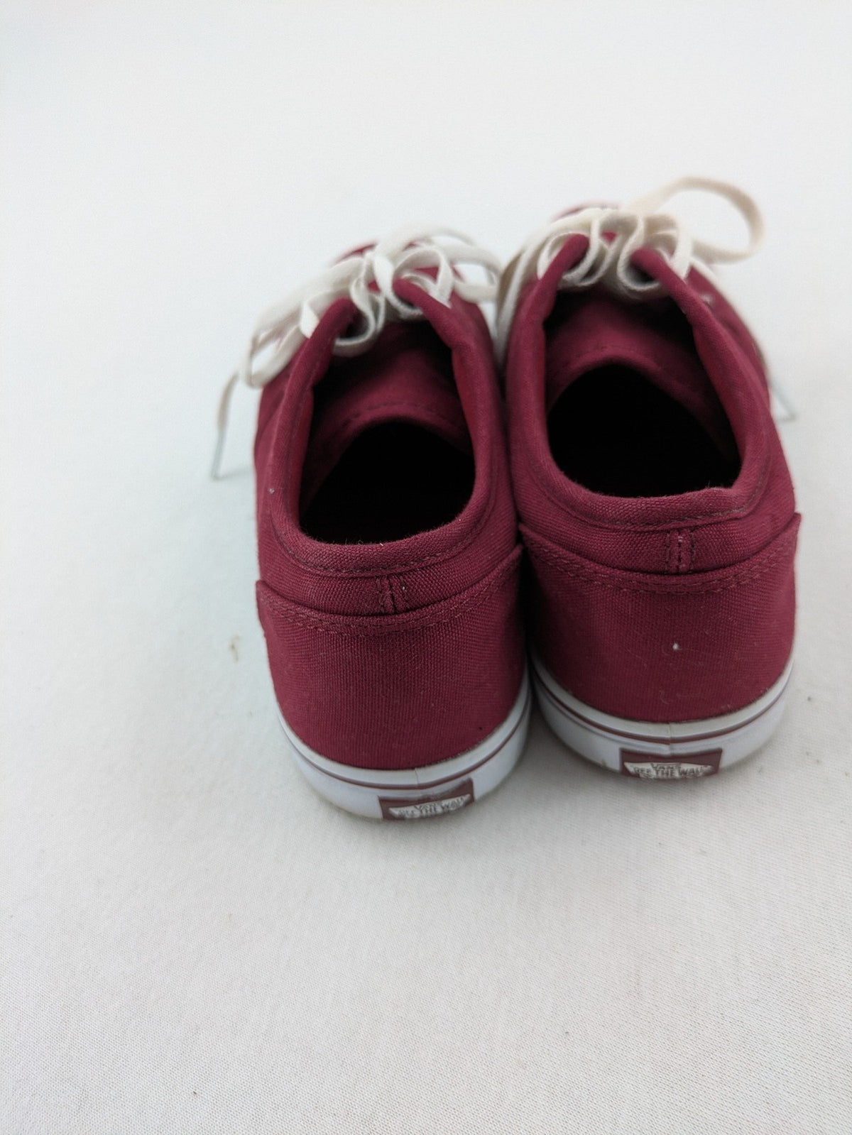 Vans low-top sneakers burgundy canvas with white logo and classic waffle sole.