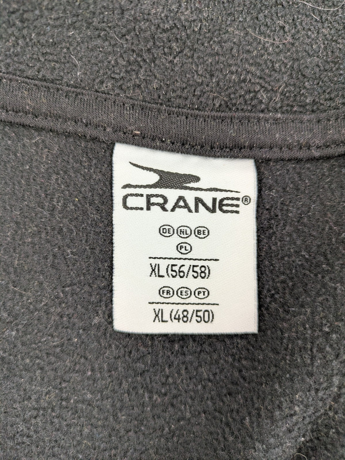 Crane beige and black fleece jacket full zip with cream accents and zippered pockets.