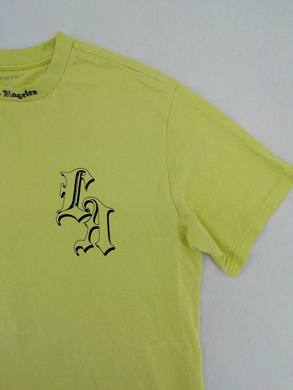 Primark yellow band t-shirt featuring Gothic LA graphic print and "PRESENT" patch.