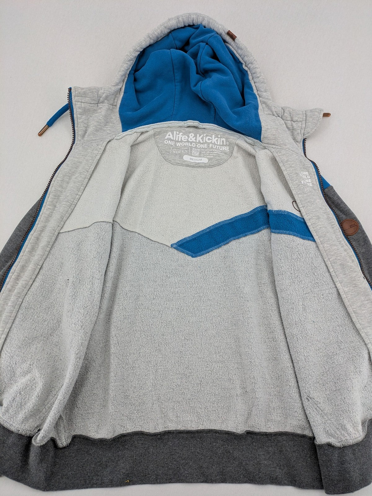 ALIFE turtle neck jumper blue grey colorblock design with logo details and soft cotton blend.