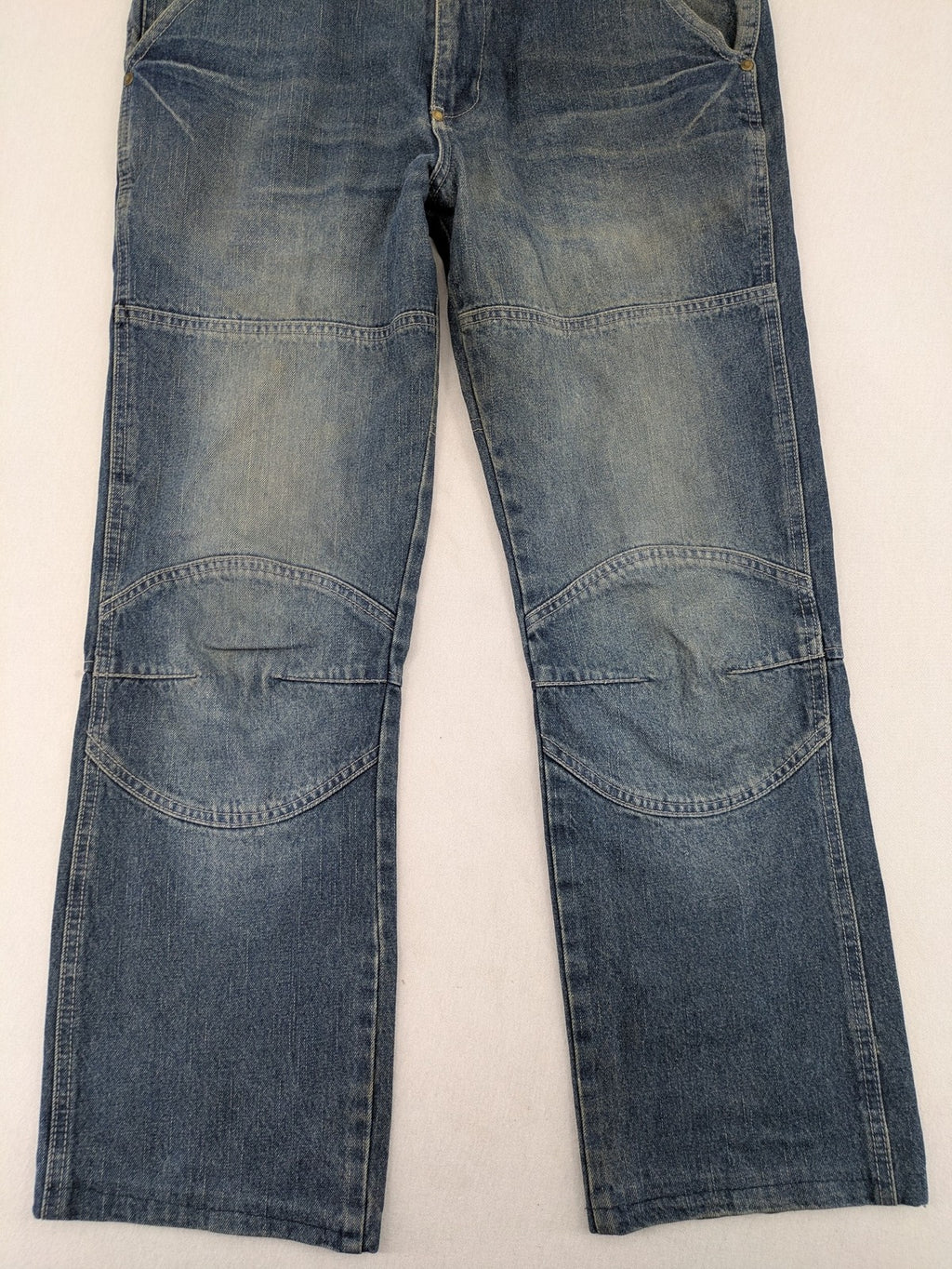 John F. Gee blue straight jeans with reinforced knees and durable denim material.