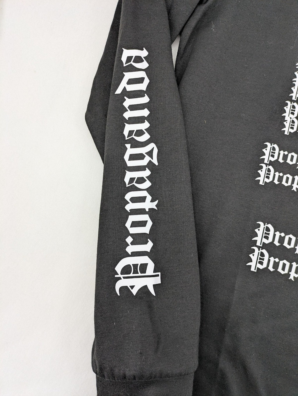 Sixth June black sweatshirt with Gothic "Propaganda" graphic print and logo details.