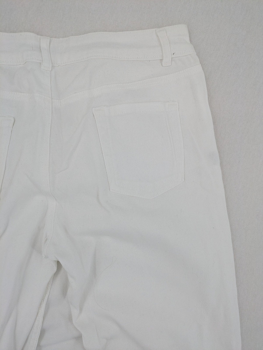 New Collection white straight jeans asymmetrical wrap design with side lacing and cotton-stretch material.