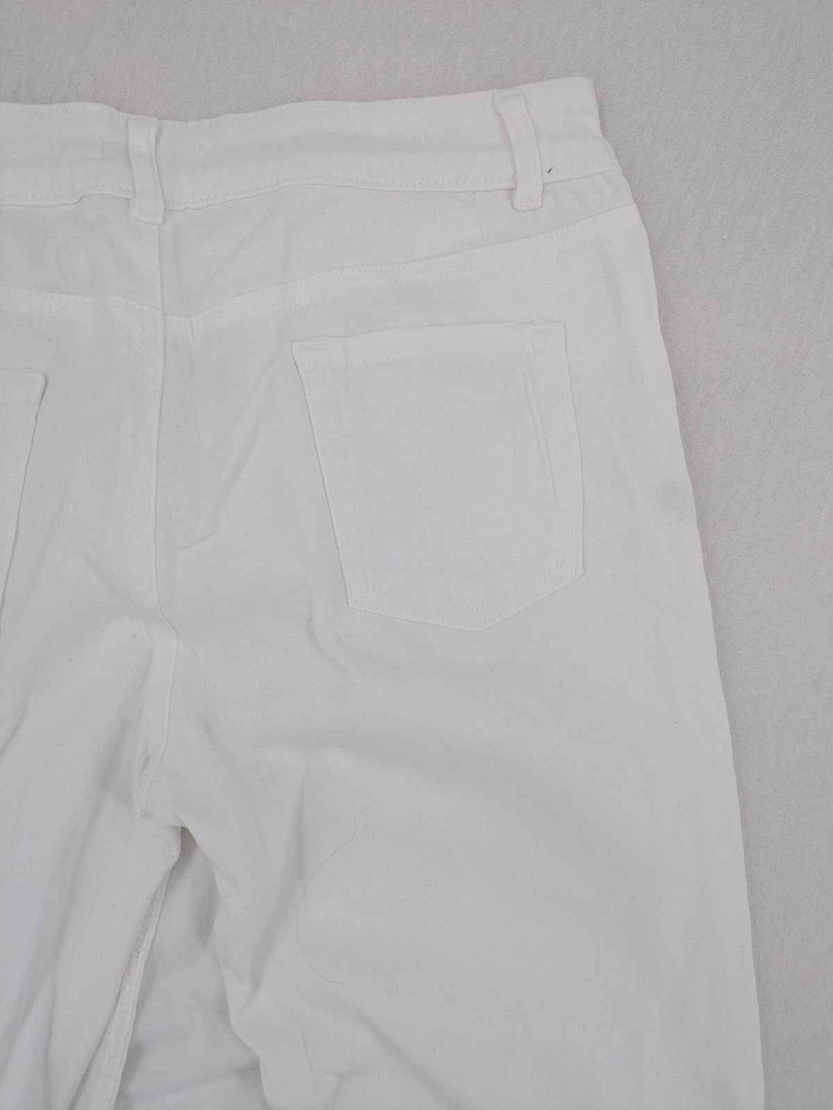 New Collection white straight jeans asymmetrical wrap design with side lacing and cotton-stretch material.