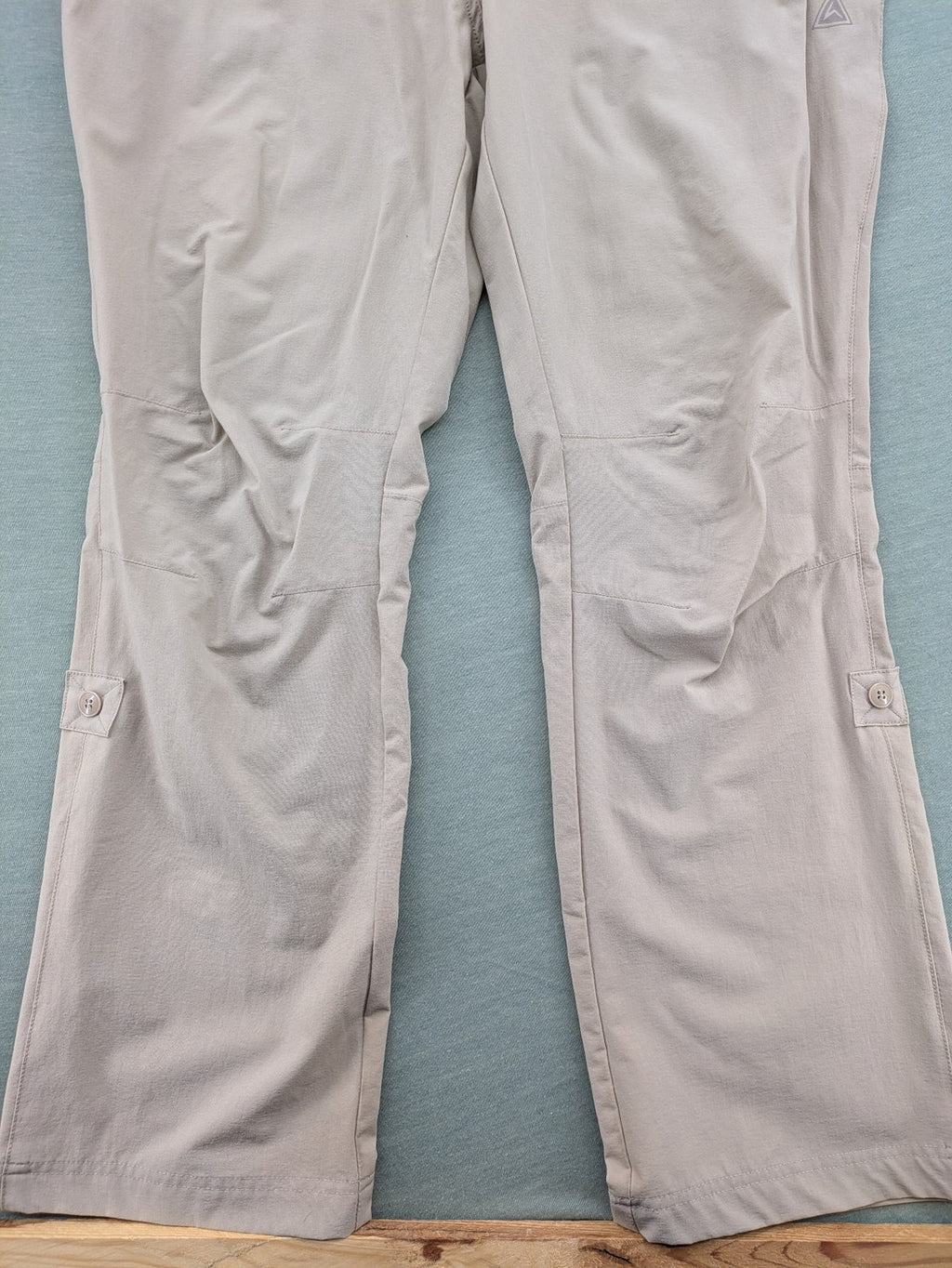 Hickory beige outdoor pants with multiple zippered pockets and stretch fabric for comfort.