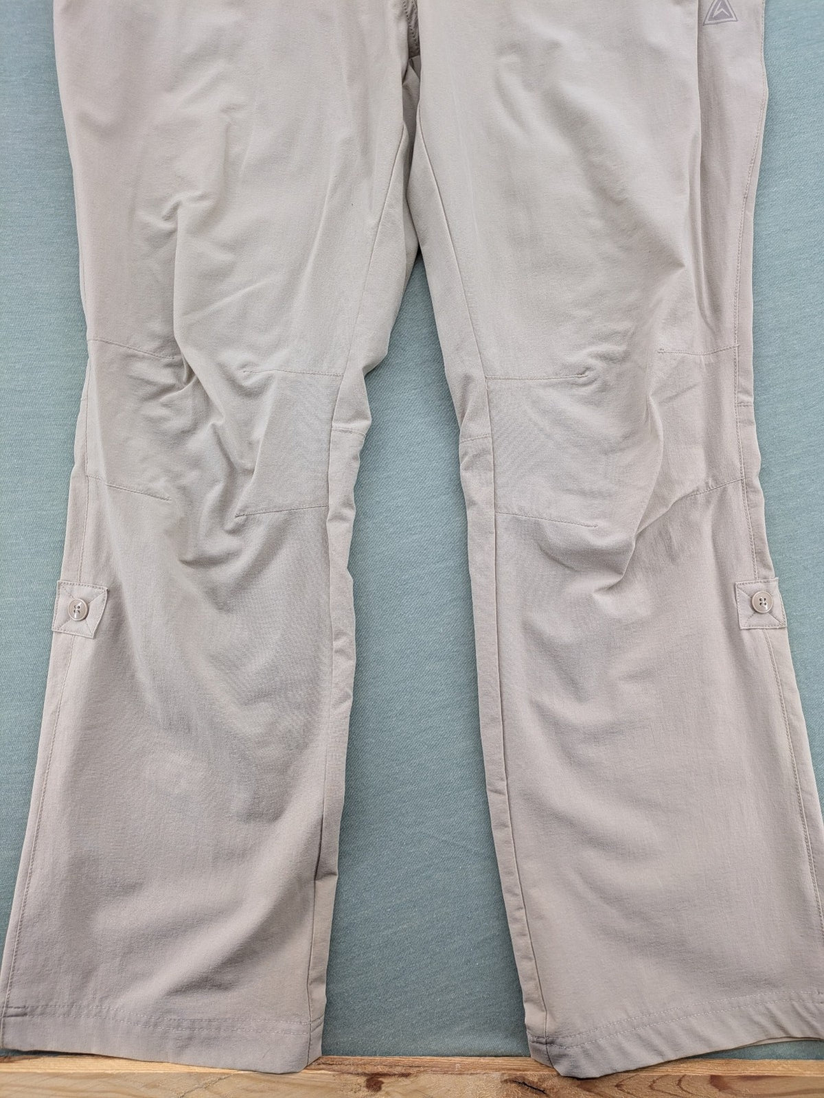 Hickory beige outdoor pants with multiple zippered pockets and stretch fabric for comfort.