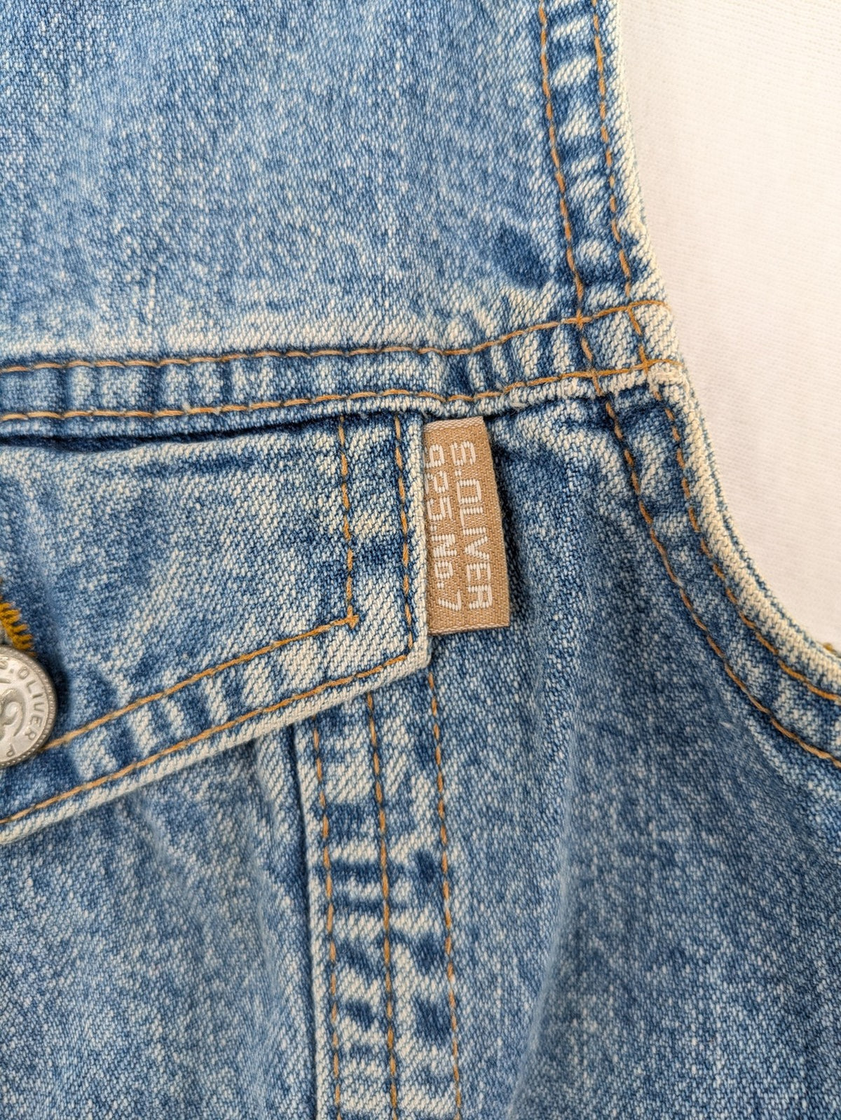 s.Oliver blue denim vest with button closure, pointed collar, and breast pockets.