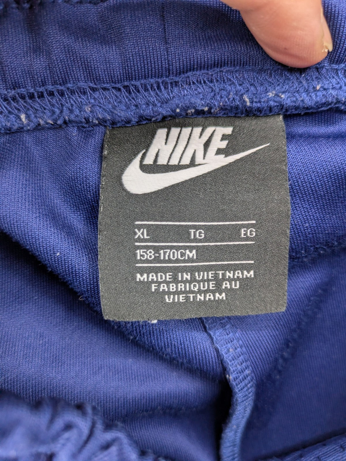 Nike Air blue jogging pants with black and white side stripes, elastic waistband.
