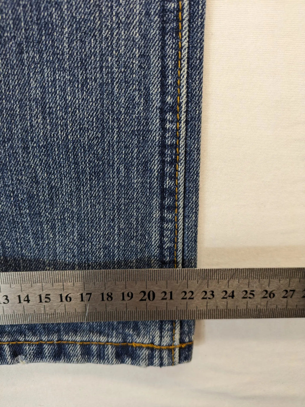 Zuni blue straight jeans 5-pocket design with zipper and decorative rivets.