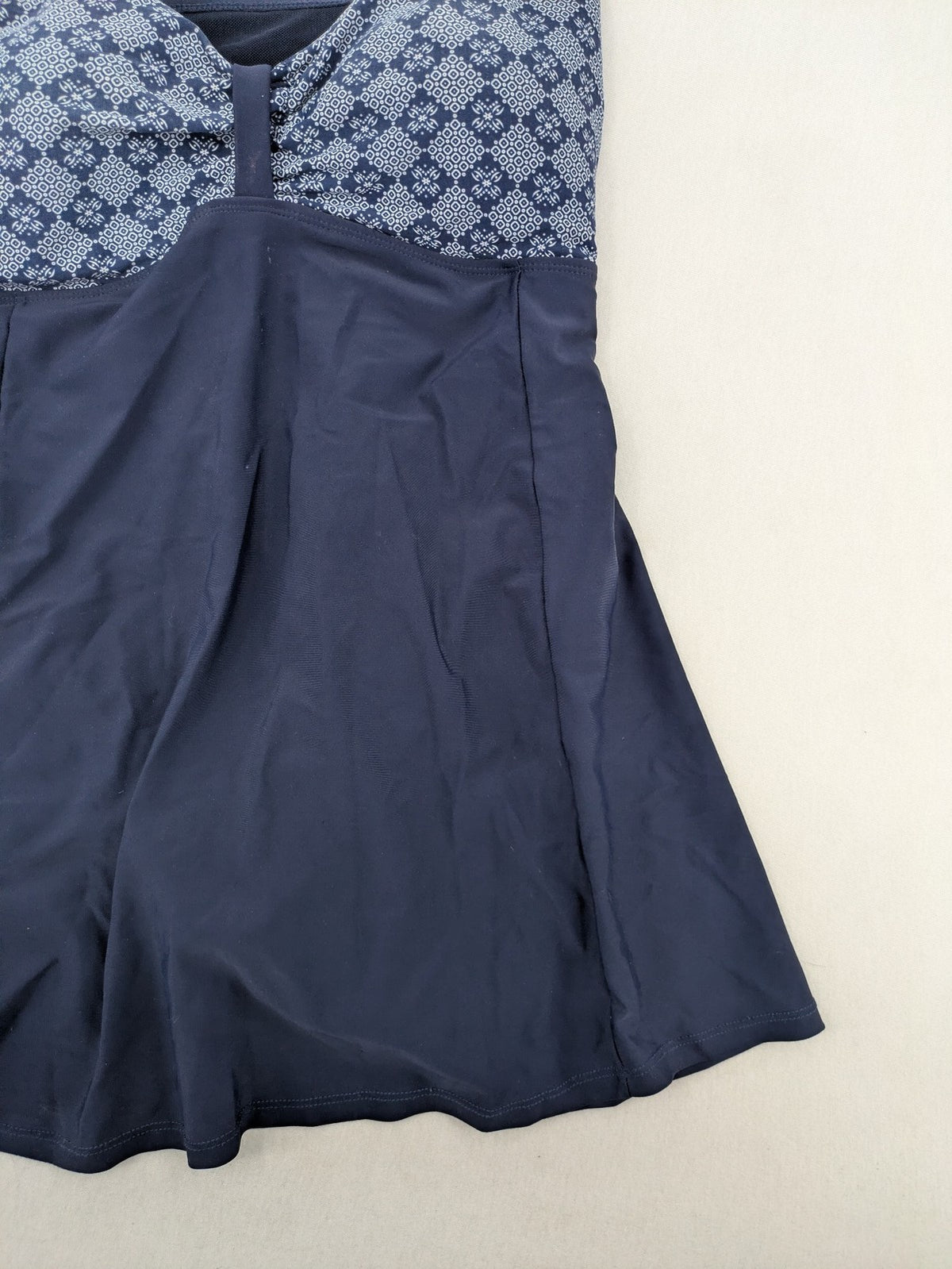 Muster blue one-piece swimsuit with geometric pattern and adjustable straps.