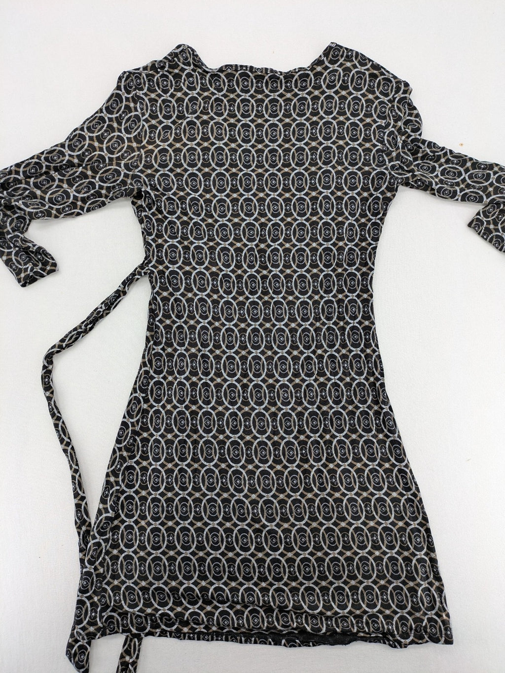 TCM pink wrap dress with V-neck, 3/4 sleeves, geometric black, white, and brown pattern.