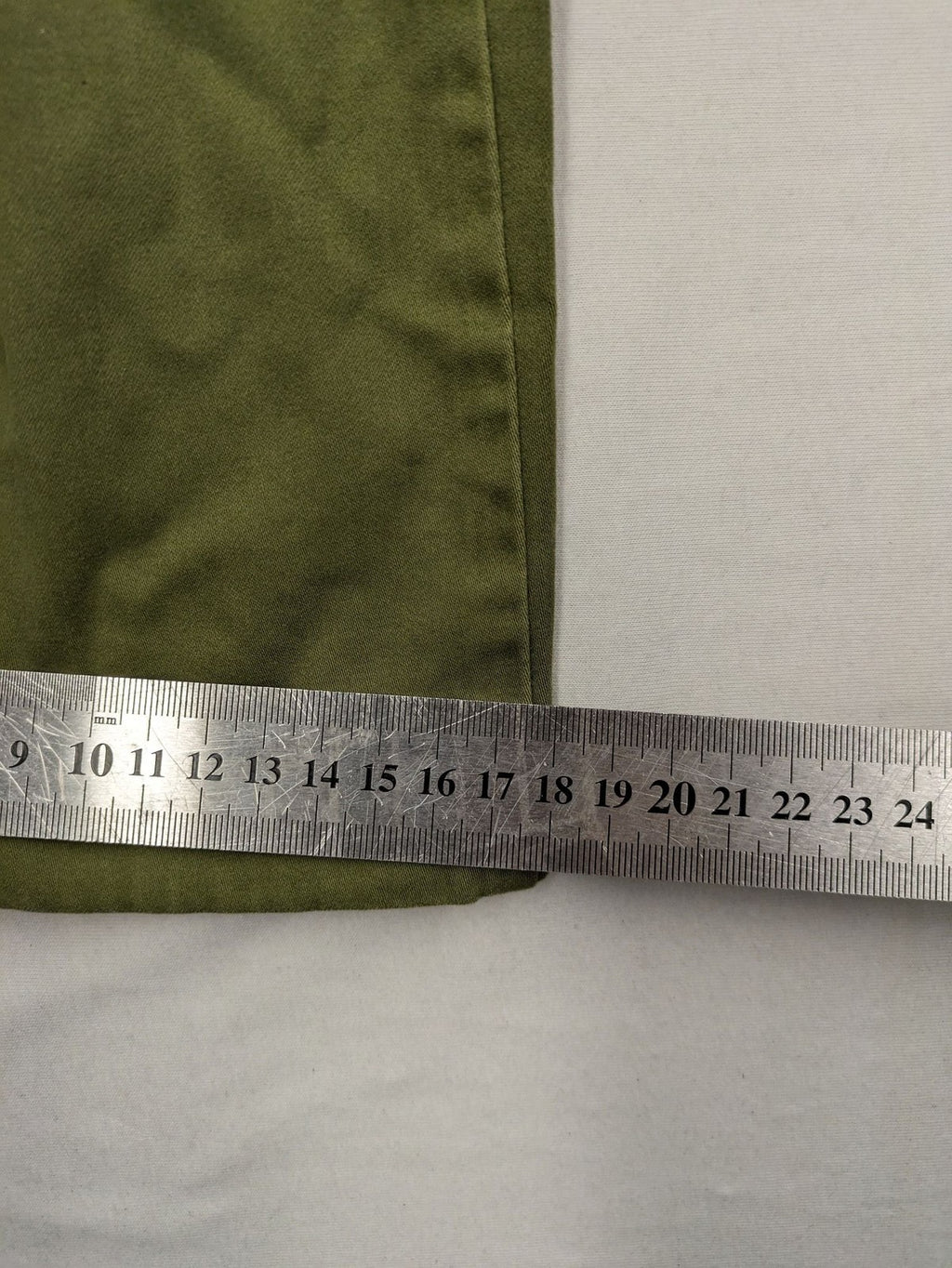 BRAX khaki pants classic five-pocket style with logo patch and zip button closure.