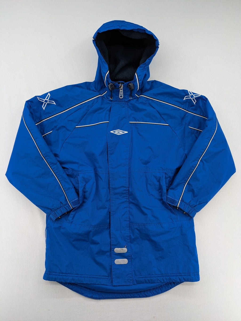 Umbro blue fleece-lined jacket with hood, reflective details, and white piping.