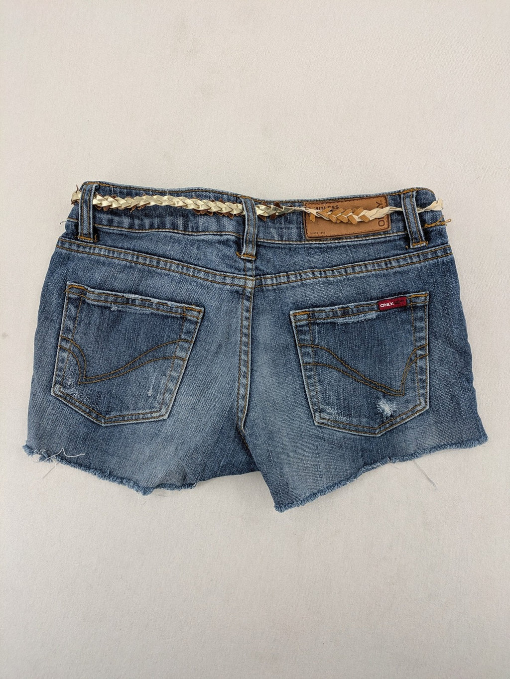 ONLY cream denim shorts with frayed hem and decorative braided gold belt