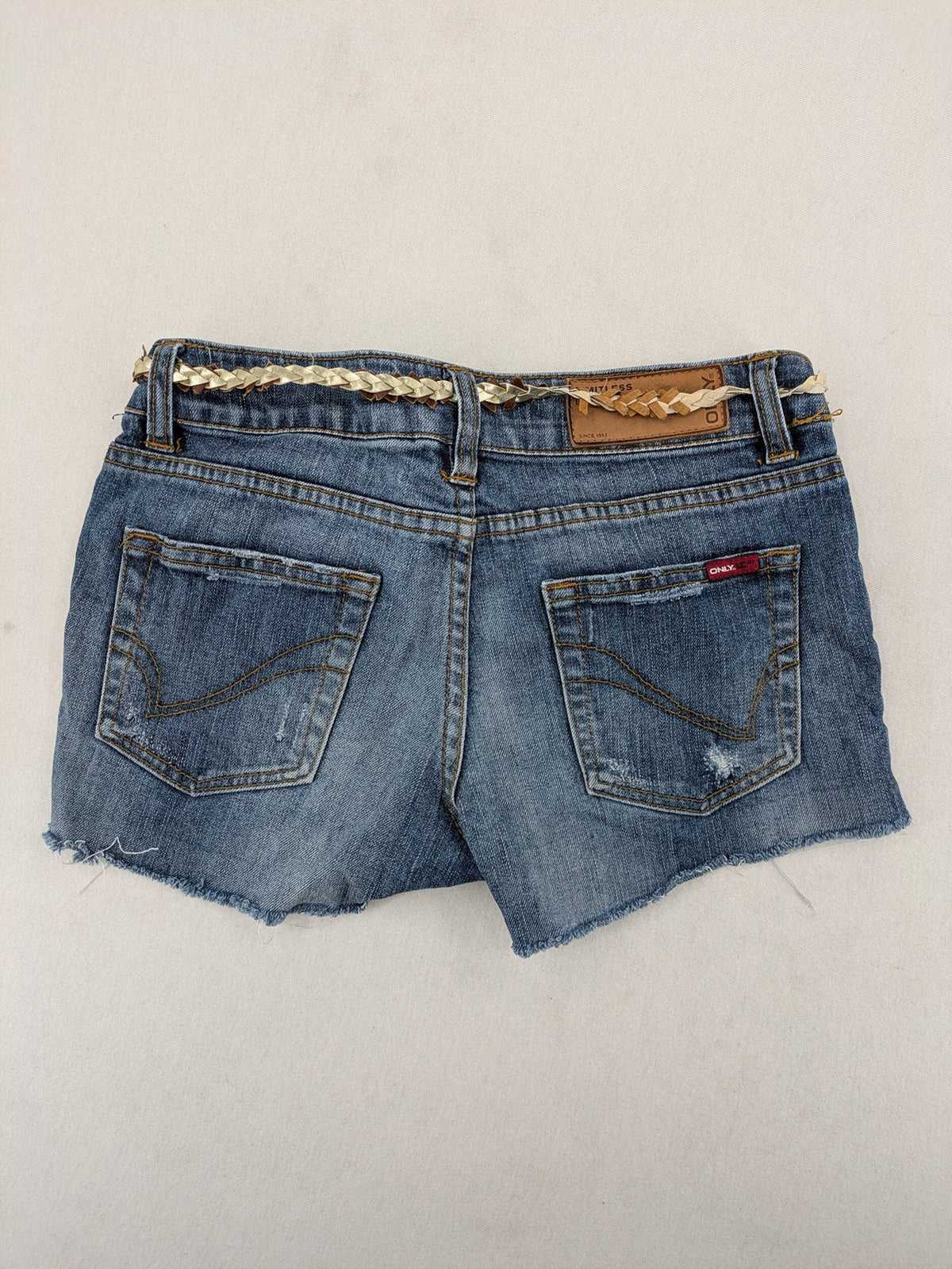ONLY cream denim shorts with frayed hem and decorative braided gold belt