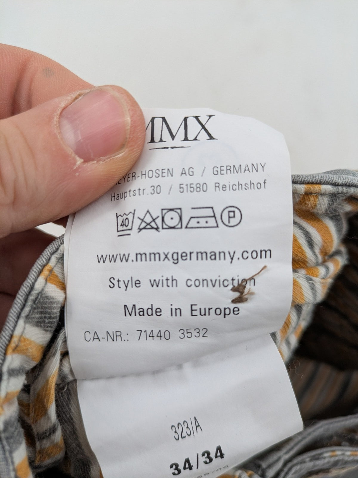 MMX grey chino pants with patterned interior lining and contrasting waistband, made from organic cotton.
