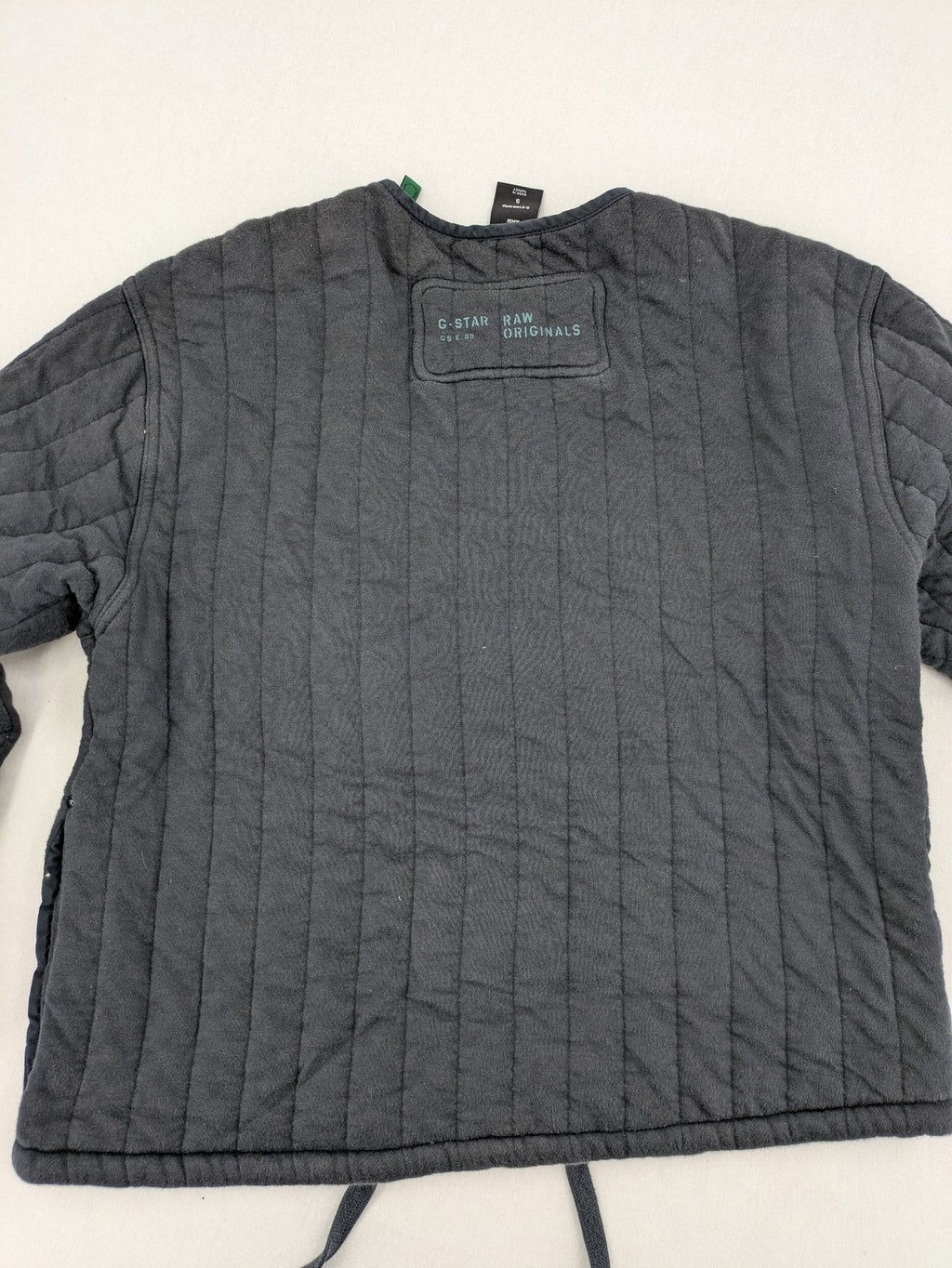 G-Star Raw grey quilted jacket with button closure and adjustable drawstring hem.