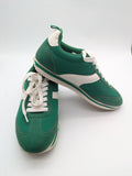 Primark green and white retro sneakers with classic lace-up design and textured rubber sole.