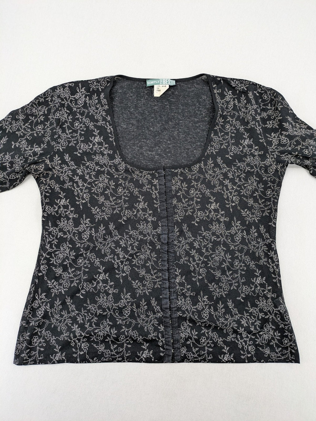 Simply The Best black top with white floral pattern and gathered front detail.