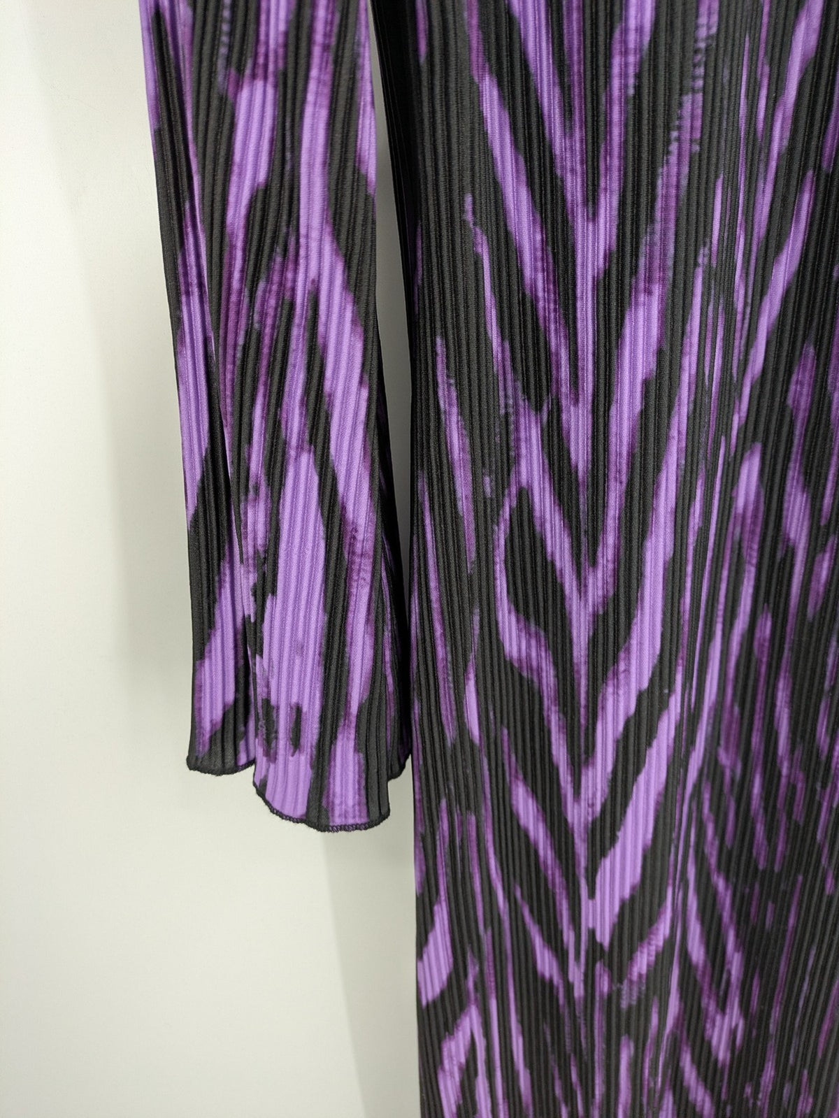 Untold black and purple pleated dress with animal print pattern and long sleeves.
