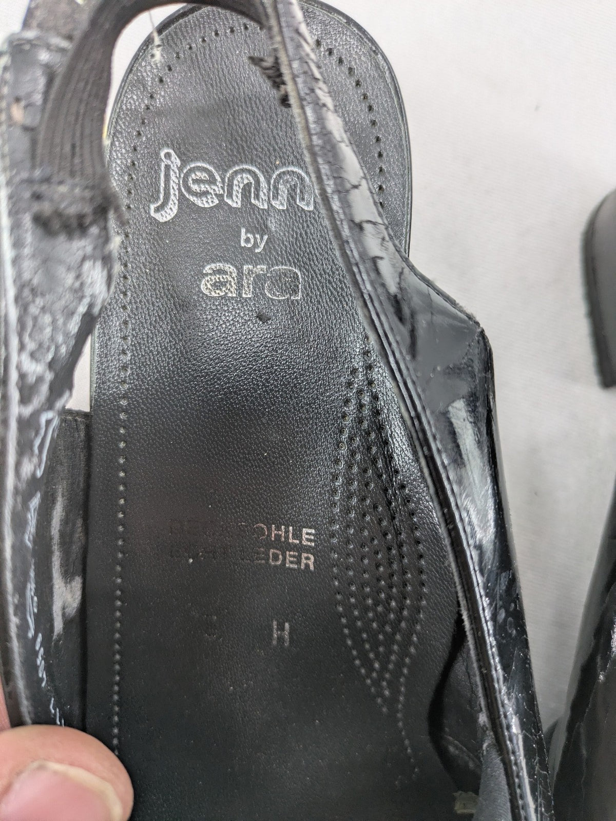 Jenny by Ara black slingback pumps with peep-toe front and glossy finish.