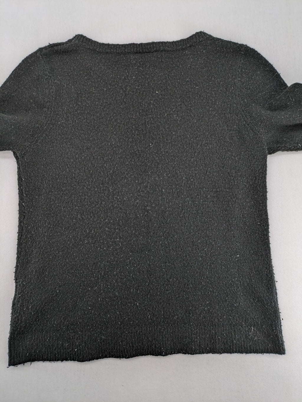 Yessica black turtle neck jumper with sequin "Let's Celebrate" graphic and star details.