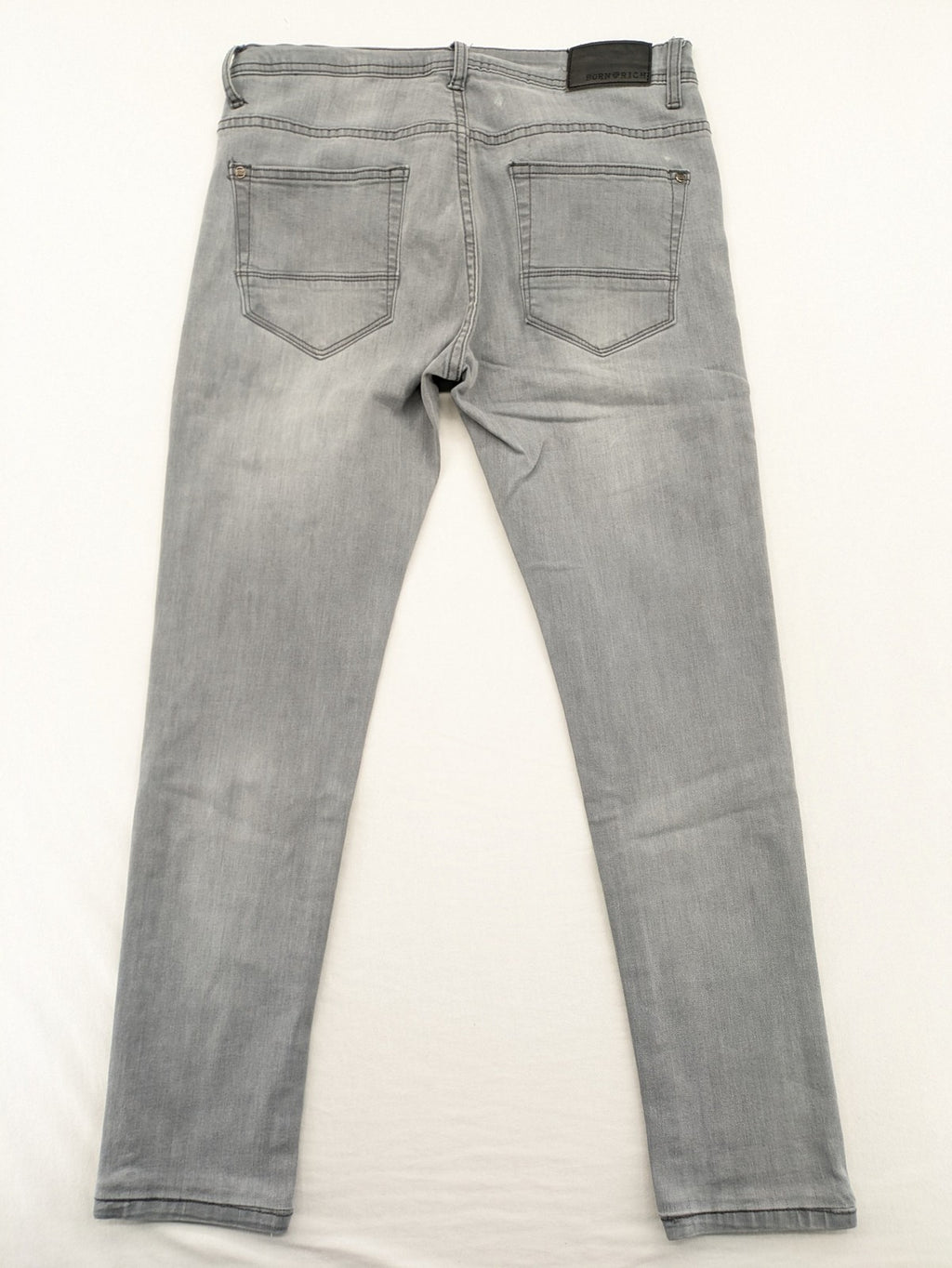 Born Rich grey slim fit jeans with logo patch and washed denim look.