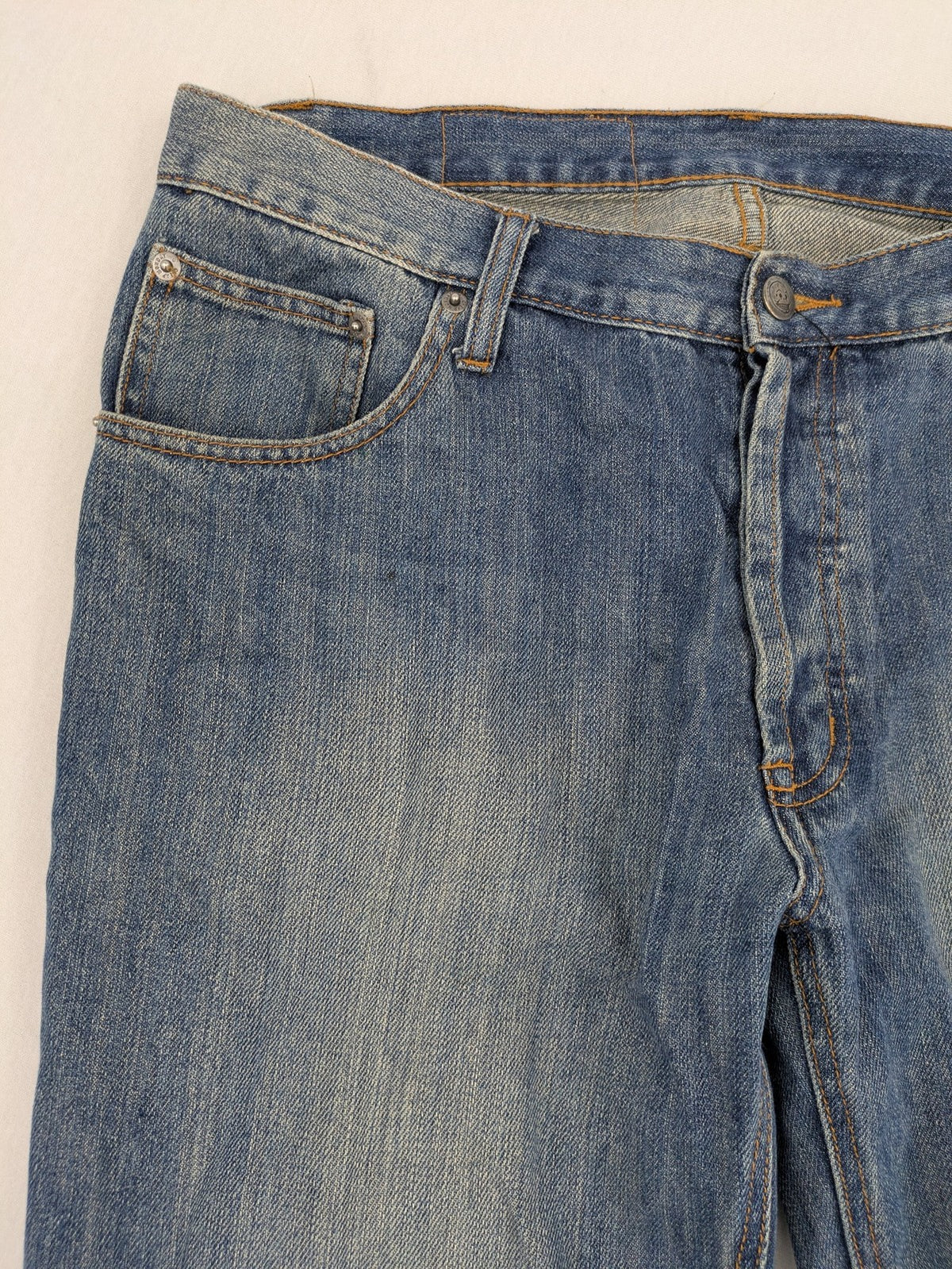 Cheap Monday blue straight jeans with button fly and classic medium wash finish.