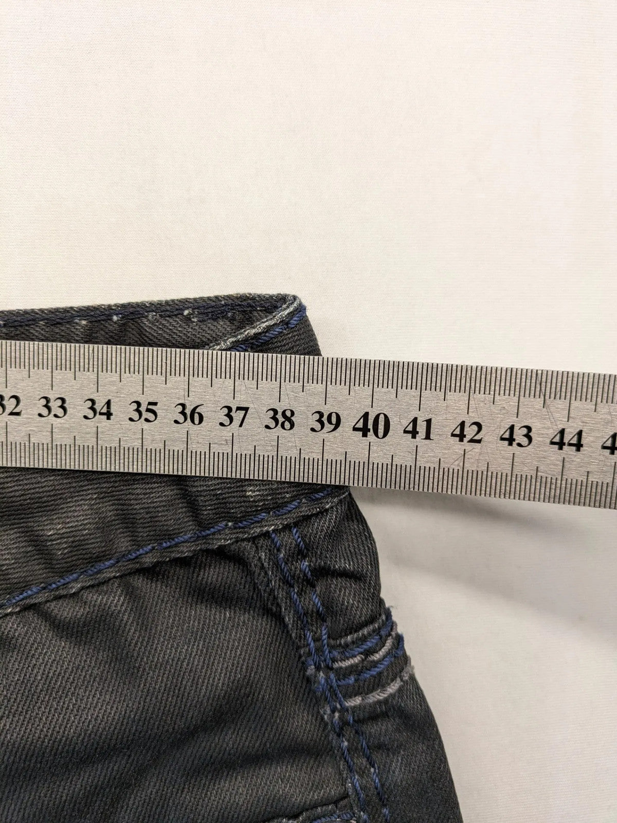 Fadnoble grey straight jeans with button fly and contrasting stitching details.